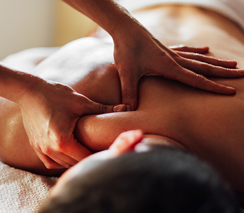 a man receiving an upper body massage from a beautician